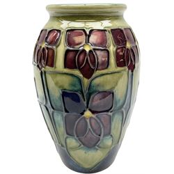 Moorcroft vase of ovoid form decorated in the 'Violet' pattern by Sally Tuffin upon green ground, with painted green mark beneath, H10.5cm