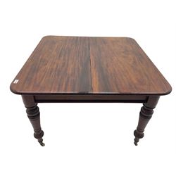 Late Victorian mahogany extending dining table, with additional leaf, raised on turned supports with brass cup and ceramic castors
