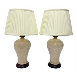 Pair of table lamps of baluster form, decorated in a mosaic pattern in a pale apricot glaze, upon a circular base, including shade H60cm
