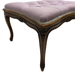 19th century French walnut dressing stool, rectangular seat with concave sides upholstered in buttoned mauve fabric, shaped moulded apron carved with flower heads, over cabriole supports with scroll feet