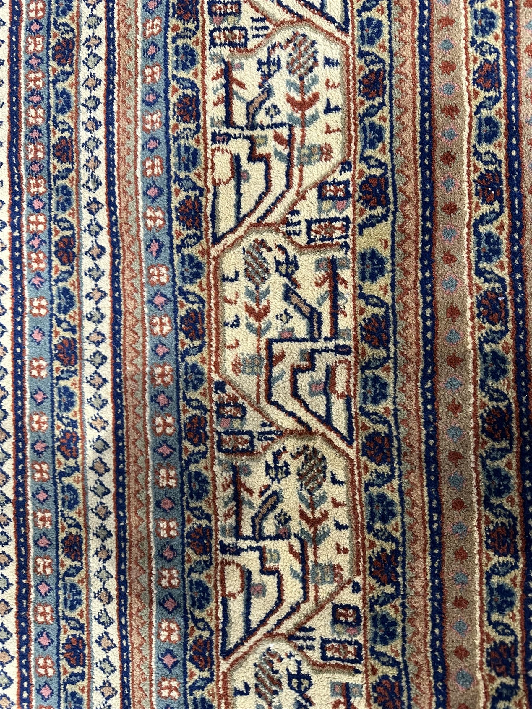 Large North-West Persian Arrak indigo ground carpet, the field decorated all-over with small Boteh motifs, multiple band border decorated with repeating geometric designs 