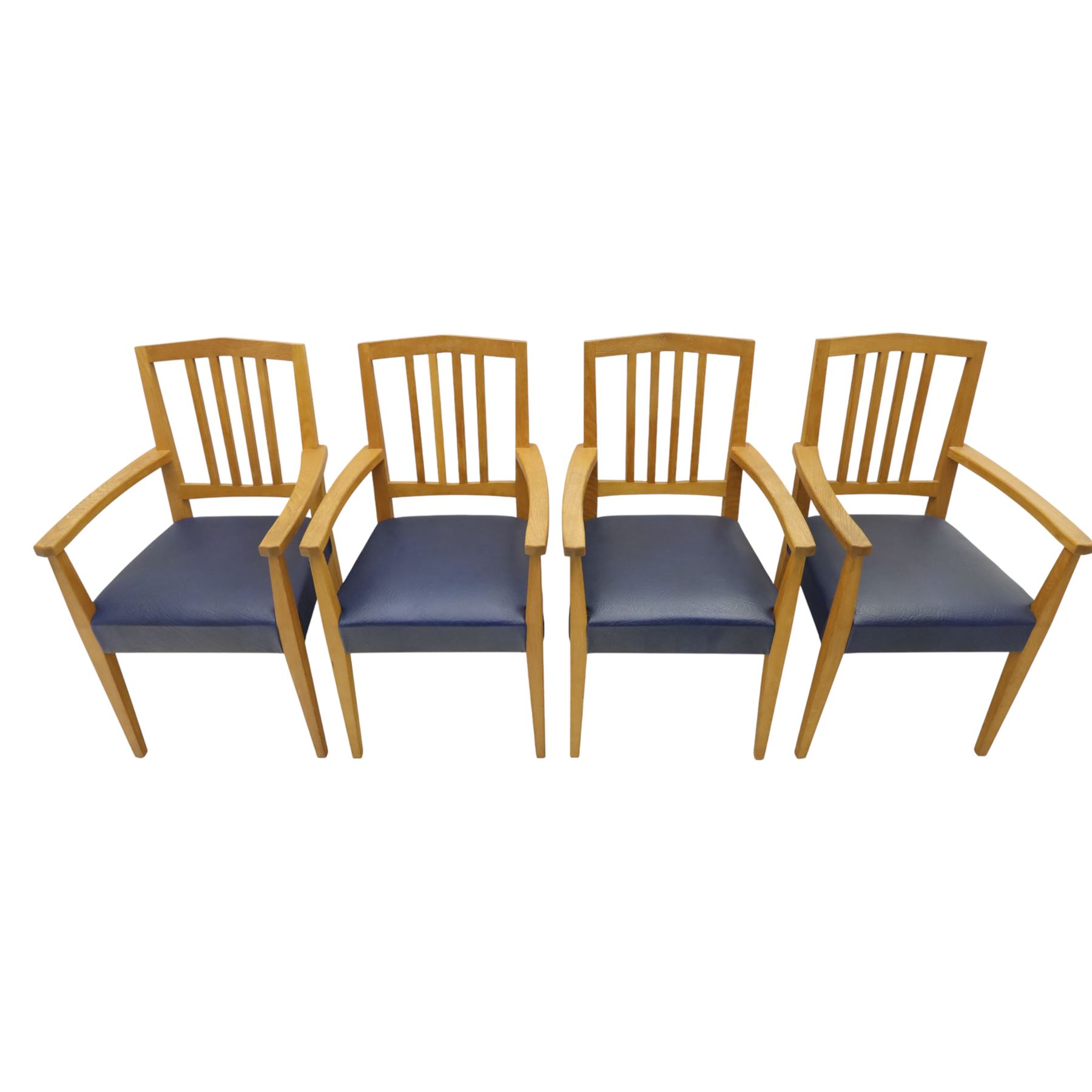 Modern twelve oak dining chairs including one 'Chairmans' chair, solid oak construction, slatted back and arm rests, blue leatherette padded seat, on tapered square supports 