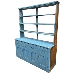Large 19th century painted pine dresser, raised open three-tier plate rack with waterfall end supports, rectangular top over two drawers and two double cupboards, enclosed by four panelled doors, in distressed blue paint finish 