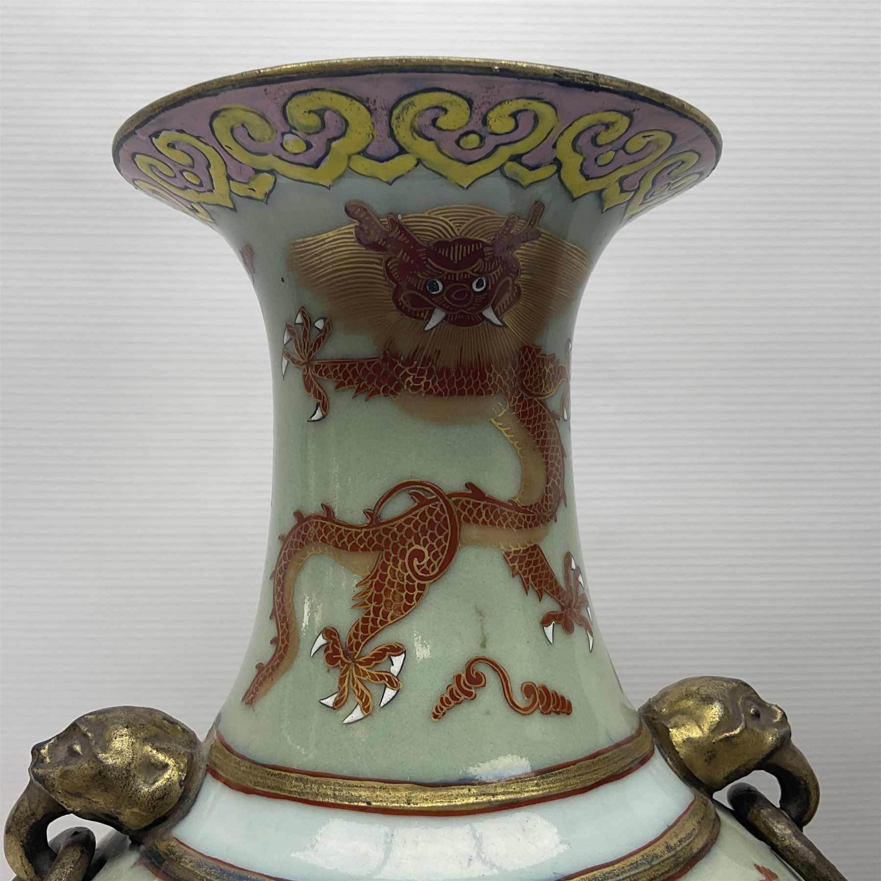 Pair of early 20th century Chinese vases decorated with dragons chasing a flaming pearl, with a gilt border of butterflies and floral sprigs, with Elephant head handles, H44cm 