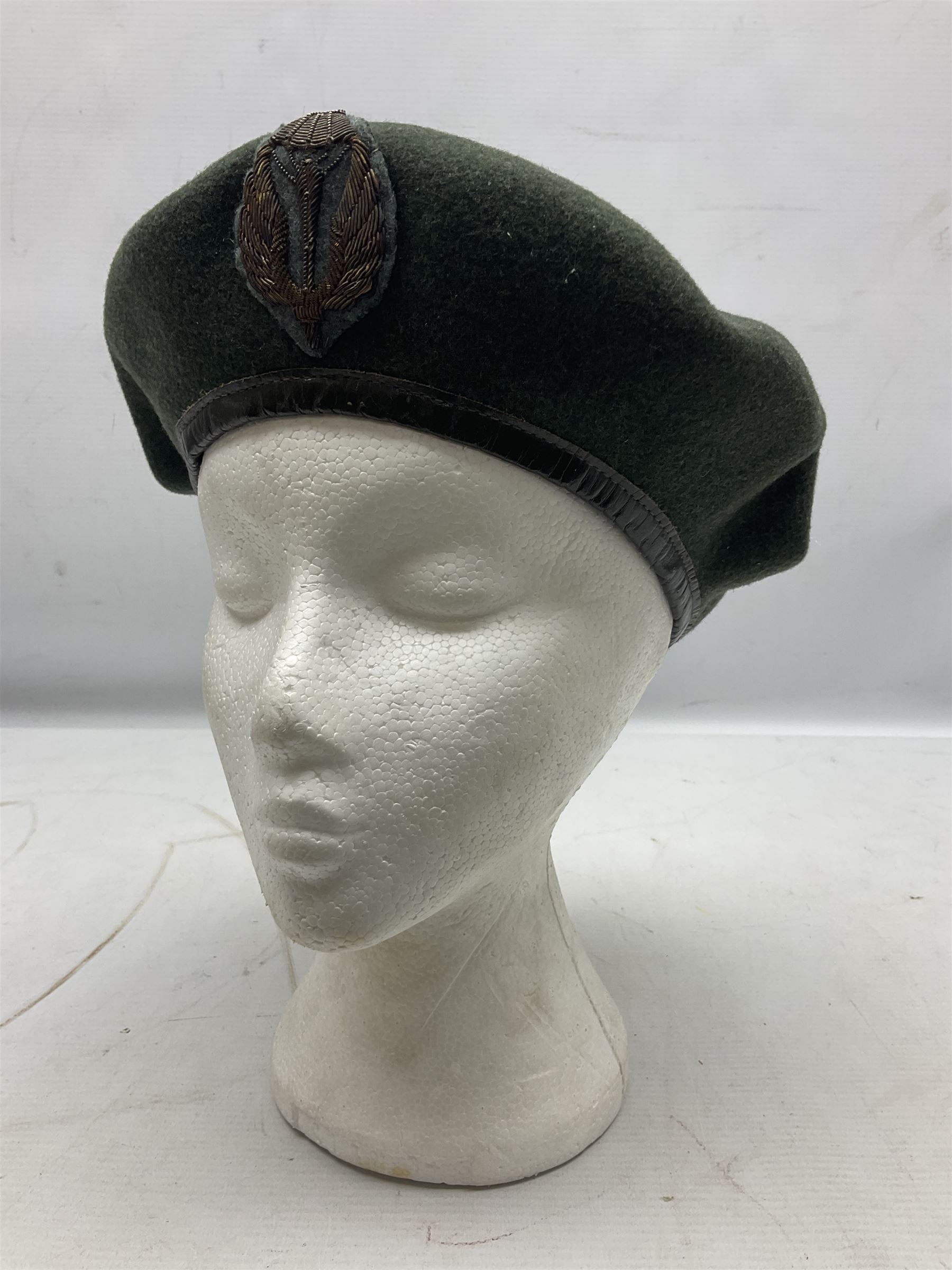 Four paratrooper berets - Russian, Italian, British and Foreign Legion; all with badges (4)