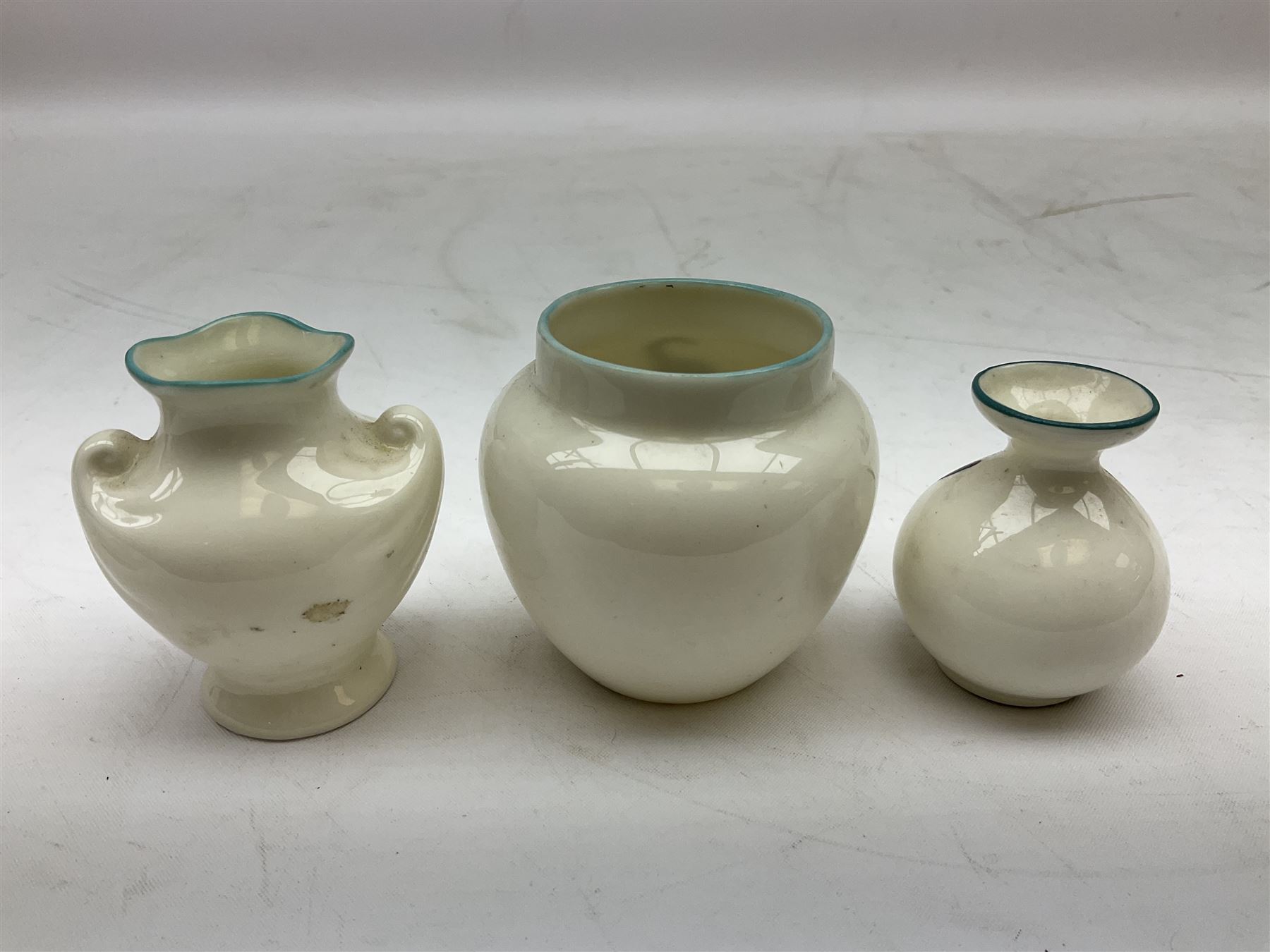 Five crested ware Good Luck black cats, comprising two Willow Art examples, two Arcadian examples and one Carlton China, to include Bridlington, Hull, Filey, etc, tallest H9cm