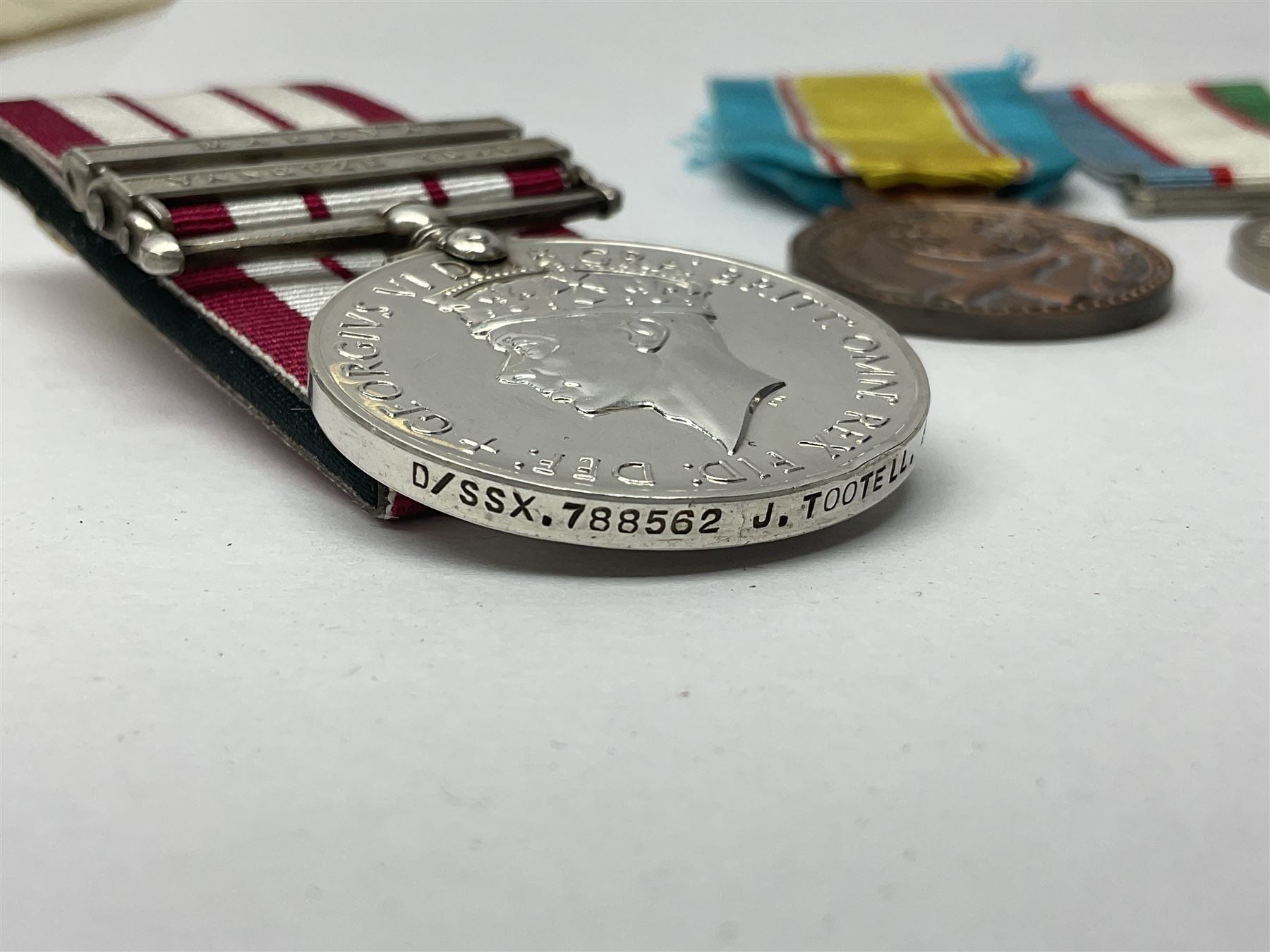1949 Yangtze Incident HMS Consort casualty Naval General Service Medal with two clasps for Yangtze 1949 and Malaya awarded to D/SSX. 788562 J. Tootell A.B.R.N.; with four other medals comprising Republic of Korea War Service Medal, Eastern Service Medal, unofficial British and Commonwealth Occupation Forces Association Occupation of Japan medal and IFKVWA 40th Anniversary Medal; together with an archive of contemporary and later related items including Certificate of Service 1946-54, Recommendations for Advancement and Conduct Record Sheet 1946-53, Quartermasters History Sheet 1949-53, Destroyer Association China Station 1945-53 beret, later manuscript journal with his own account of the Yangtze incident etc, Joe's birth certificate details dated 1968, reprinted half-length portrait in uniform, Manual of Seamanship 1937, modern shield and framed crests, blazer badges and metal badges and a copy of Loyal & Steadfast - The Story of HMS Consort 2008, which gives details of how Joe Tootell received his wounds, the extract reads ' When Consort came under fire a short time later it was a strange, perhaps unreal experience for many of the crew who had never seen action before. Ordinary Seaman Joe Tootell was in the wheelhouse. 'I could not see the action. We could hear the ship taking severe punishment. When the wheelhouse took a direct hit, killing the coxwain, Chief Petty Officer Gurney, and myself receiving multiple shrapnel wounds, the steering mechanism was put out of action.'