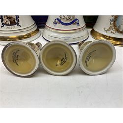 Bells, Scotch whisky, in seven Wade ceramic decanters, comprising two Christmas decanters 1990 and 1991, 60th birthday of Queen Elizabeth II decanter, Golden Wedding anniversary of the Queen and the Duke of Edinburgh decanter, Birth of Princess Beatrice decanter, Birth of Princess Eugenie decanter and Queen's mothers, together with Bells, blended Scotch whiskies, three miniatures in Wade ceramic decanters, various contents and proofs