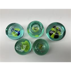 Five Victorian glass paperweights with flower inclusions, tallest example H7cm