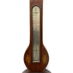 Early 19th century William IV mercury wheel barometer with a rosette inlaid broken pediment and correspondingly inlaid round base, mahogany veneered case with inlaid oval conch shell paterae and satinwood stringing to the edge, with an arched thermometer box and spirit thermometer measuring degrees Fahrenheit from 20 to 120, eight-inch silvered register reading barometric pressure in inches from 28  to 31, with predictions in Roman upper and lower case and script, dial inscribed “A Tagliabue,24 Grenville Street, Luther Lane, London”, with a steel indicating hand, brass recording hand and cast brass bezel.