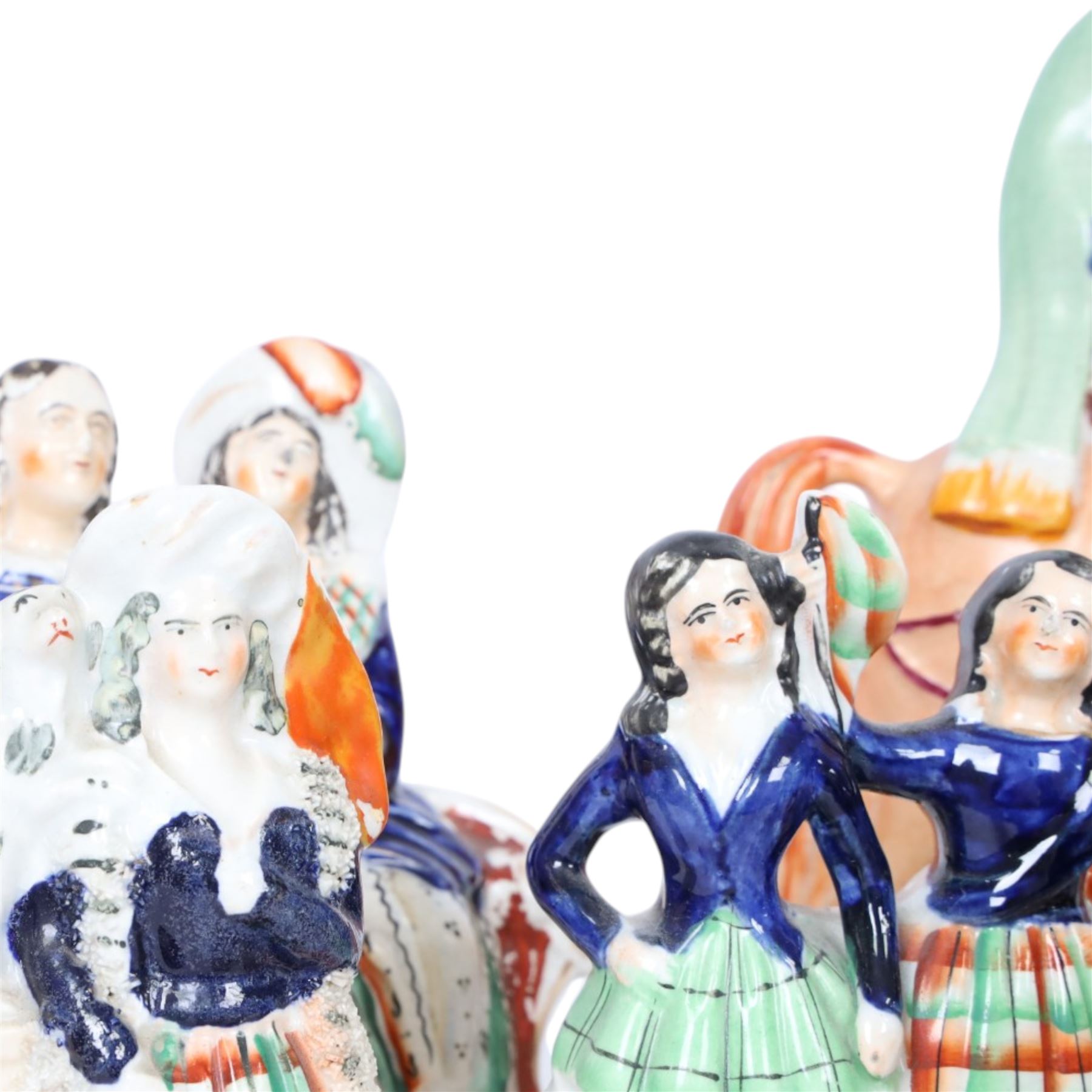 Group of Staffordshire figures, mostly Highland examples, to include figure with bagpipes upon horseback, figure group of Highland Mary and Byron, two figure groups depicting pair of dancers holding flag aloft, two pairs of recumbent sheep, one pair with fags, largest example H30cm