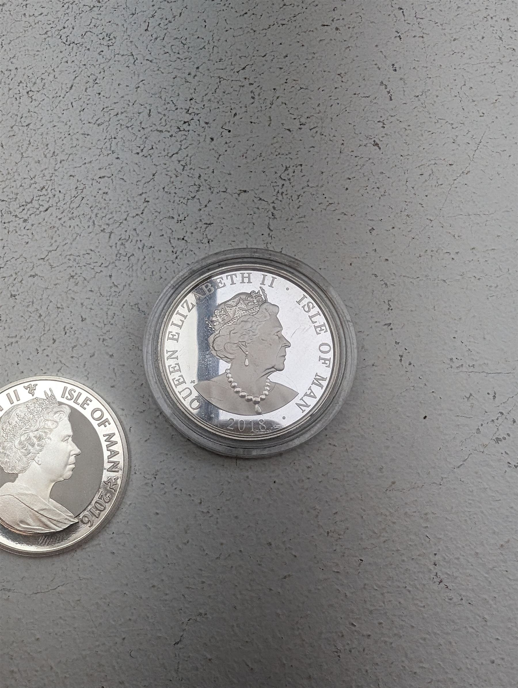 Three Queen Elizabeth II Isle of Man one ounce fine silver coins, comprising 2016, 2018 one angels and 2018 one noble 
