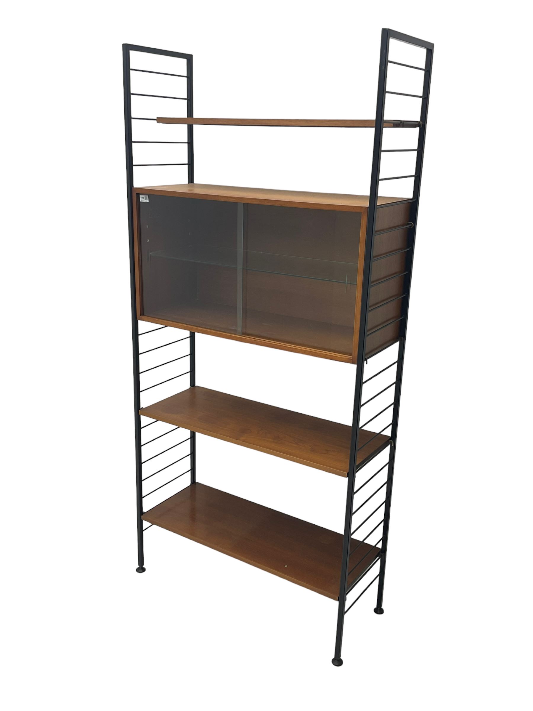Staples Ladderax - mid-20th century teak and metal framed modular wall unit, fitted with central cupboard, the sliding glazed doors enclosing single shelf, flanked by three adjustable shelves 
