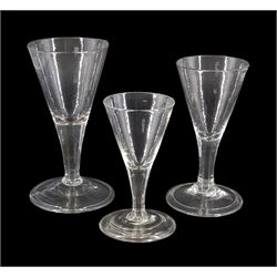 Three graduated 18th/19th century short ale glasses, with drawn funnel bowls upon plain stems and folded conical feet, tallest H13cm 