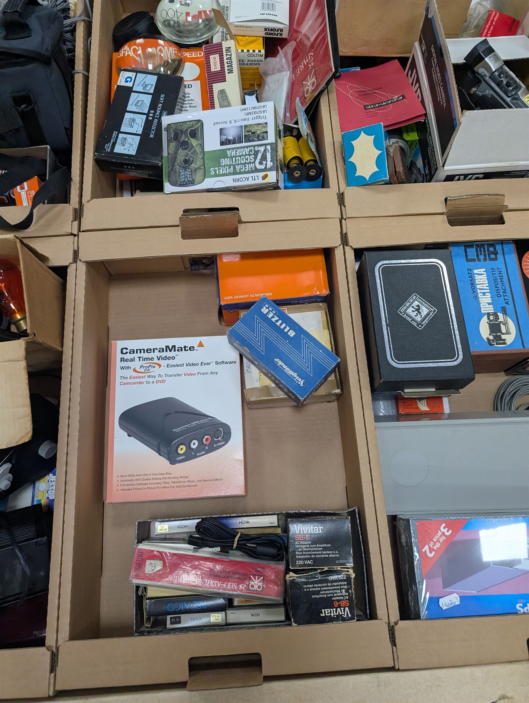 Large collection of photography equipment, including two video cameras JVC and a Panasonic 3CCD, tripods, filters, photograph paper, developing equipment, Dalite projector screen, etc, some boxed some empty boxes, and a Midgard Pocket Microscope