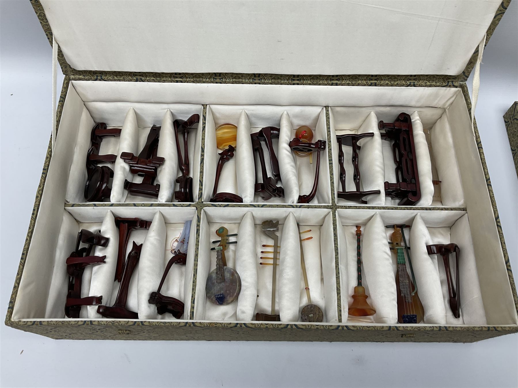 Chinese boxed collection of miniature polished hardstone musical instruments with hardwood stands
