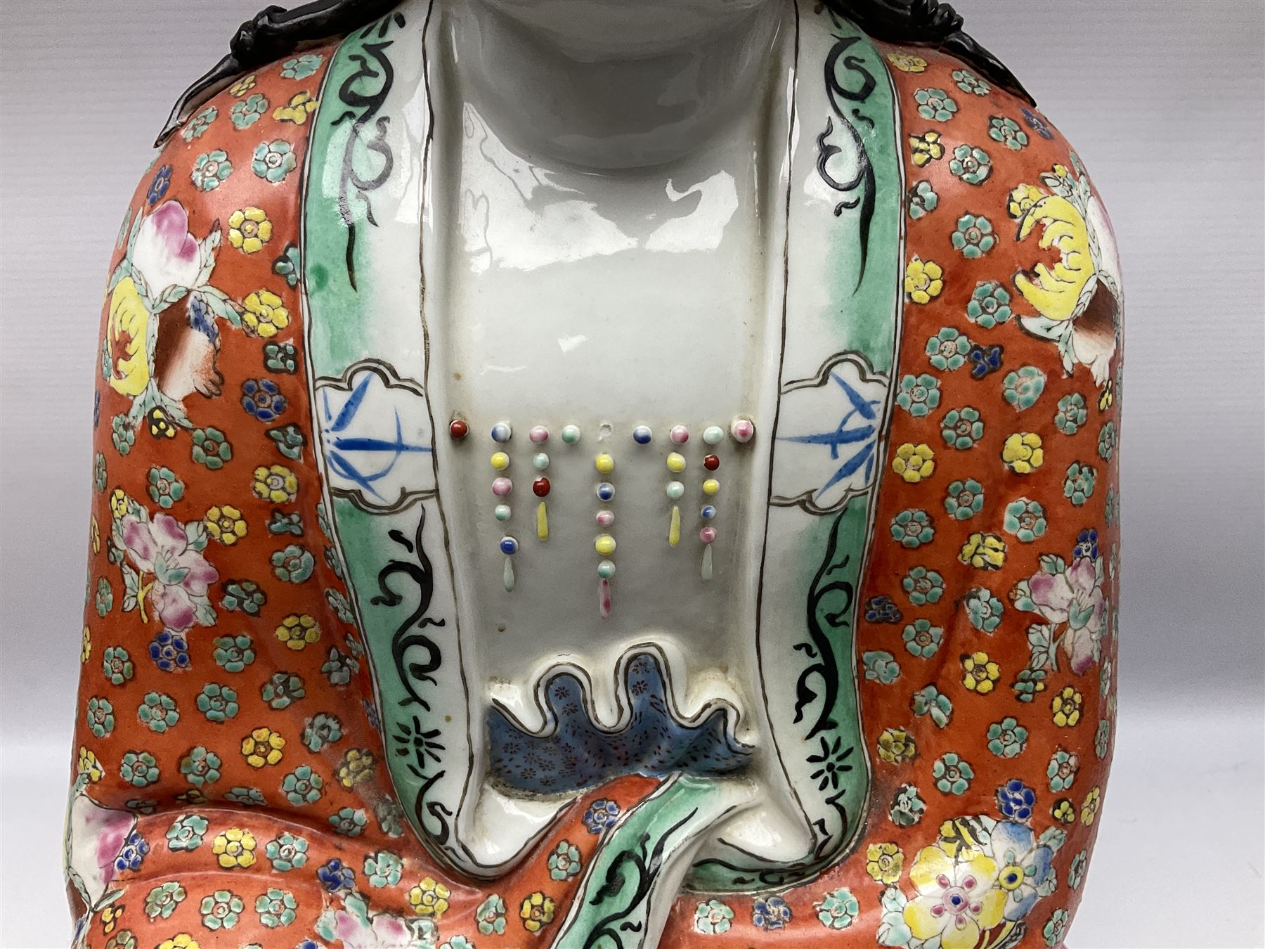 Tall Chinese polychrome figure of Guanyin (Guan Yin), the Goddess of Mercy and compassion, the Bodhisattva modelled seated and holding a rosary donning elaborate floral robes and beads, with four character seal marks beneath, H53cm