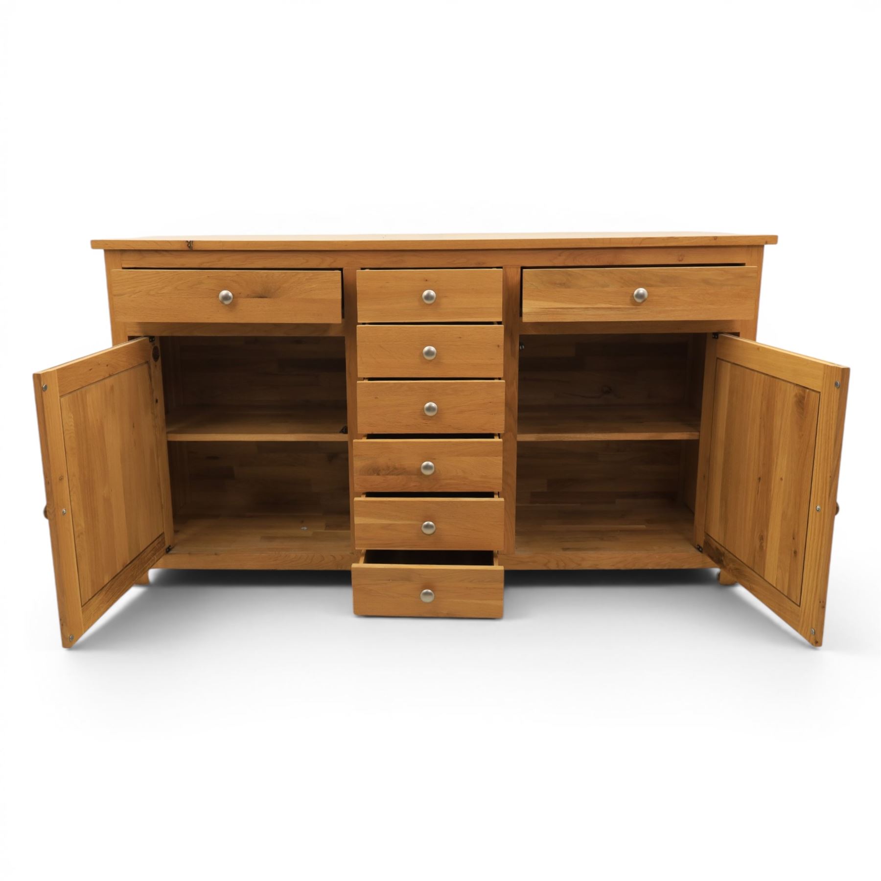 Solid oak sideboard fitted with drawers and cupboards, central bank of six drawers, metal pulls 