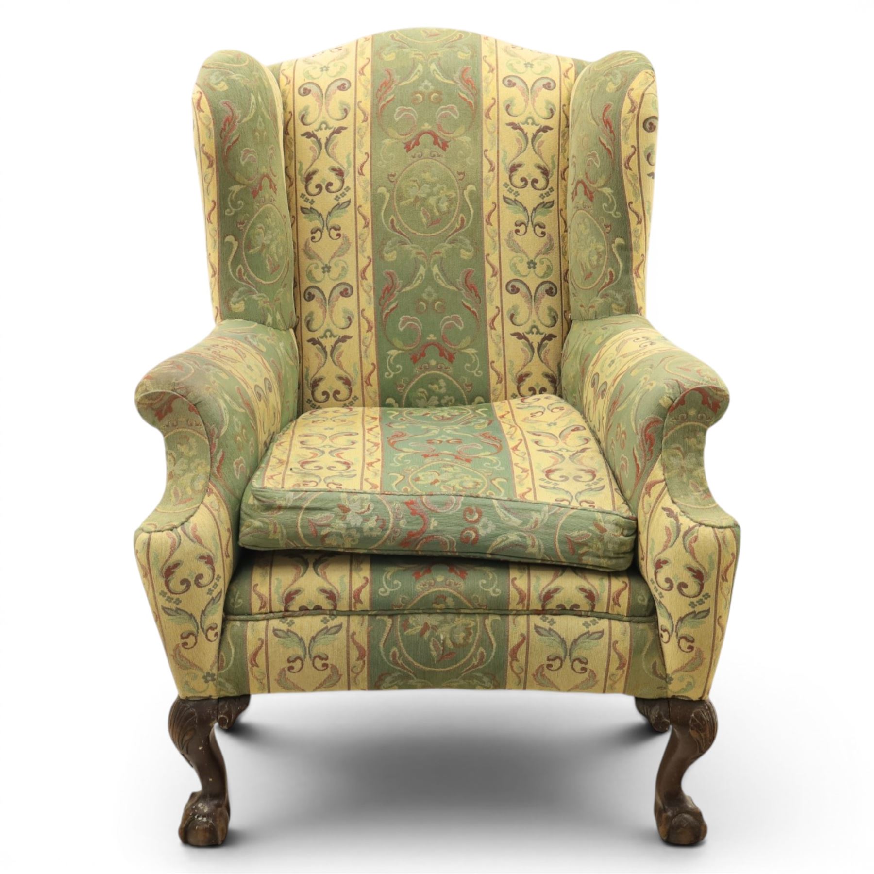 Queen Anne style wingback armchair, upholstered in green and cream foliate fabric, shaped arms on ball and claw feet