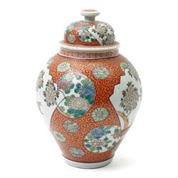 Japanese vase and cover decorated with panels of exotic birds in a fenced garden setting on orange and gilt scroll ground marked Zoshuntei Sanpo Zu H30cm