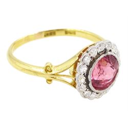 Early 20th century gold tourmaline and diamond cluster ring, milgrain set single stone pink tourmaline of approx 1.35 carat, surrounded by sixteen old cut diamonds, to a split design scroll shank, stamped 18ct, total diamond weight approx 0.30 carat