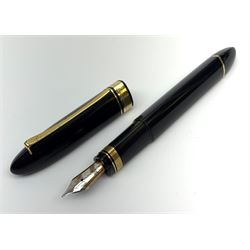 An Omas 360 fountain pen, the black triangular section body with gold coloured clip and banding, and Greek Key border to the cap, the bicolour nib marked 750 18K.