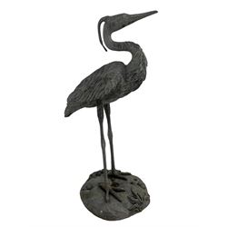Life-size lead garden figure in the form of a heron, on a naturalistic base decorated with shells and seaweed 