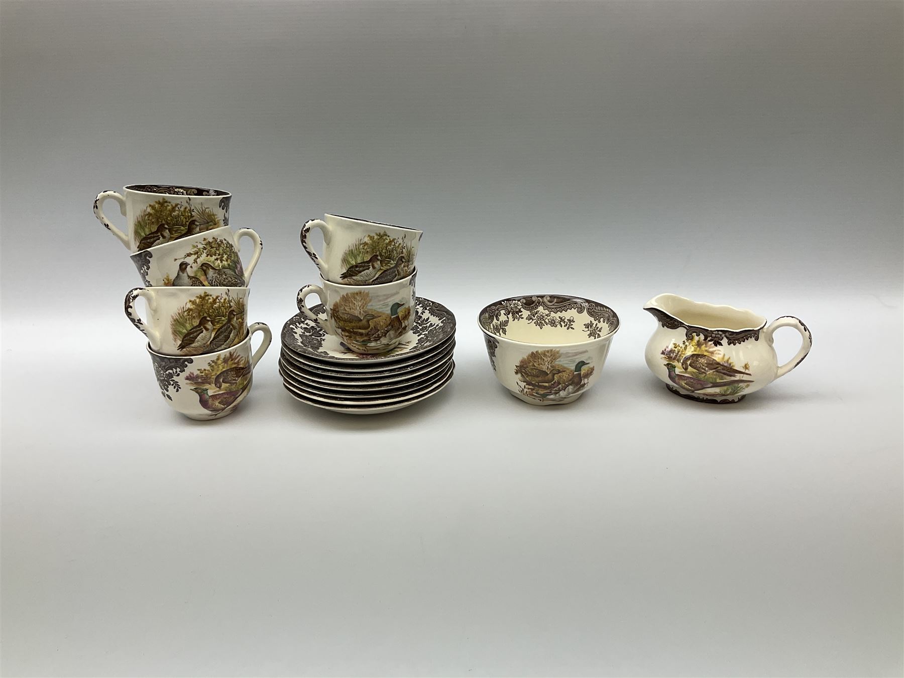 Royal Worcester Palissy Game Series pattern dinner wares, comprising seven dinner plates, six side plates, twelve bowls, sauce boat and stand, six tea cups, eight saucers, further larger saucer, milk jug, and open sucrier. 