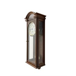 Comitti,  London - 20th century 8-day chiming wall clock in a walnut case, with a moulded break-arch top and full length glazed door and side panels, two part enamel dial with spade hands and visible gridiron pendulum, three train spring driven movement chiming the quarters on 5 gong rods.