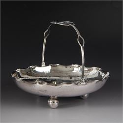 Chinese export silver swing handled basket, of circular for with crimped rim and knotted wirework handle, engraved with a dragon to centre, upon three bun feet, with maker's mark T.H, character marks and 95 to underside, including handle H17cm