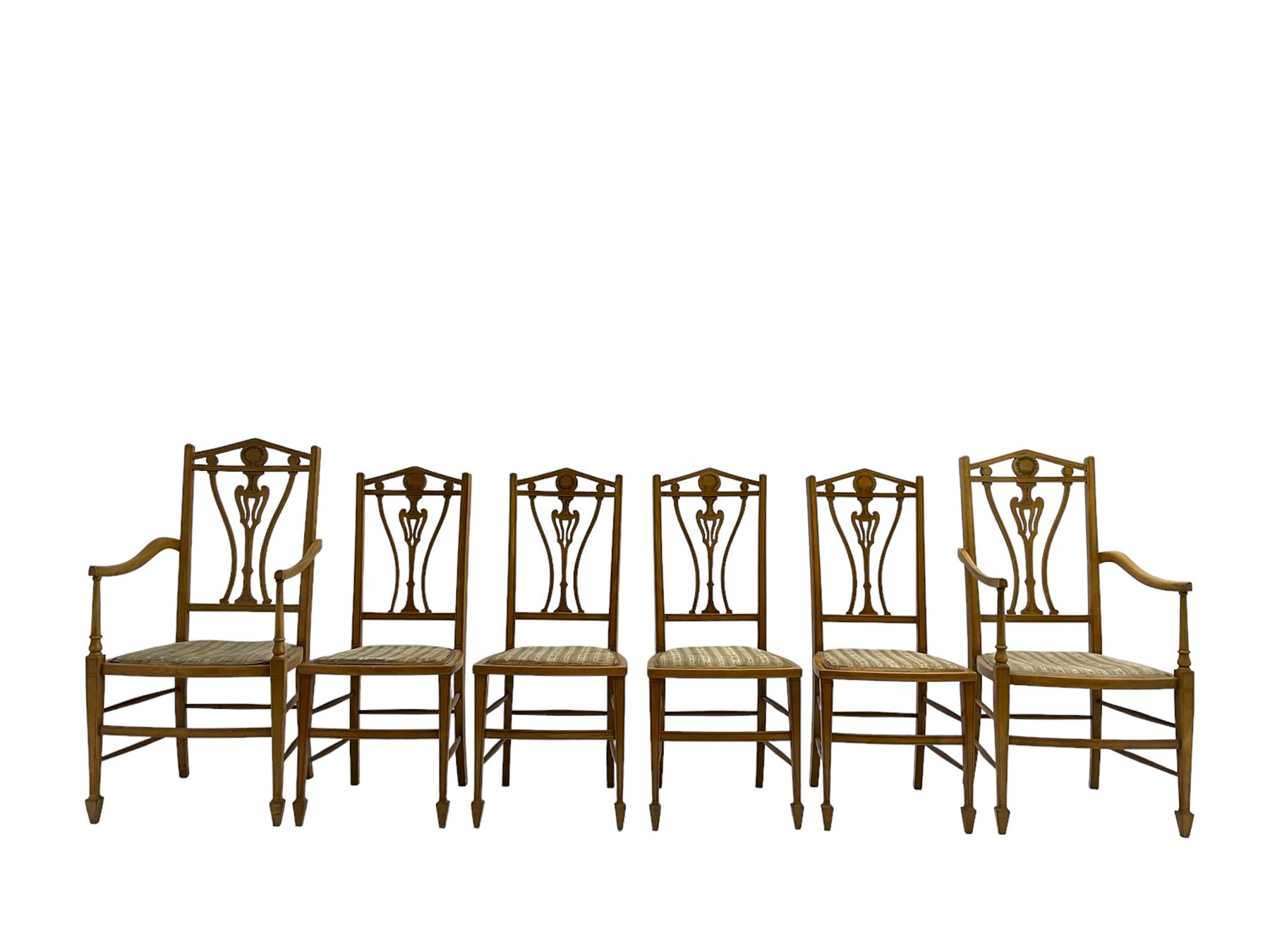 Set six (4+2) Edwardian satinwood dining chairs, triangular cresting rail painted with laurel wreath, shaped and pierced splat flanked by two shaped upright rails, with boxwood stringing, upholstered seats, on square tapering front supports with spade feet