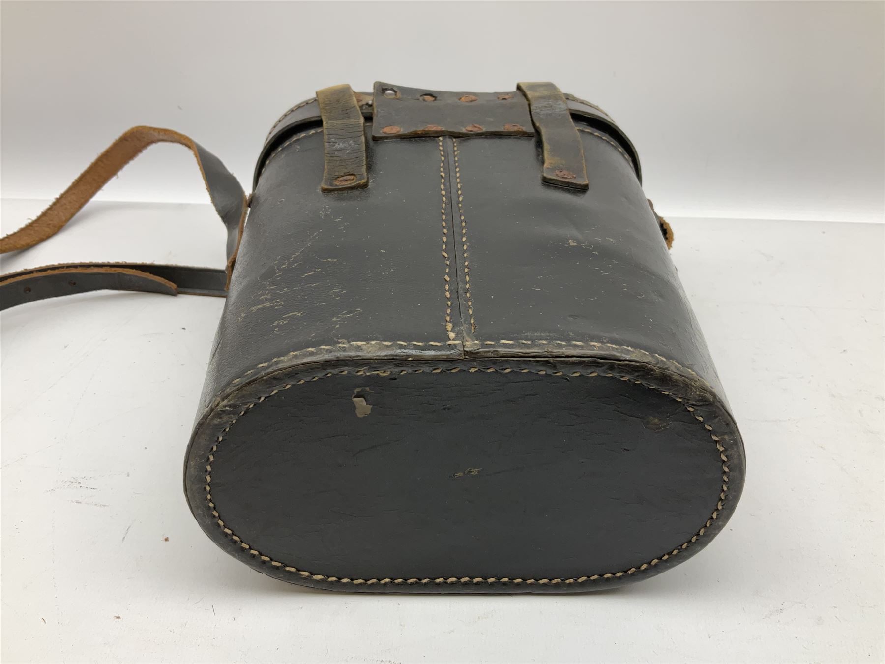 Pair of WWII German U-boat binoculars probably 7 x 50 by Leitz, with rubber eye piece protector covers and leather case stamped with Kriegsmarine mark to the lid and dated 1944, with leather strap.