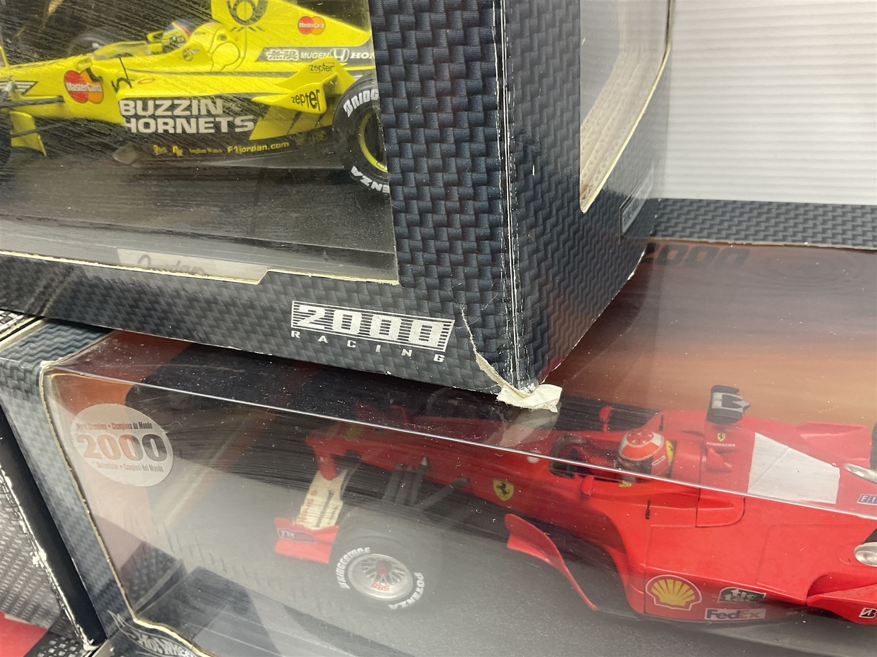 Five Mattel Hot Wheels 1:18 scale die-cast racing cars - Ferrari F1-2000 Michael Schumacher; Ferrari F-2002 Michael Schumacher; Jordan E-110 Heinz-Harald Frentzen; Williams F1 Team FW23Juan Pablo Montoya; and Ferrari F2001 Rubens Barrichello; all boxed (5)