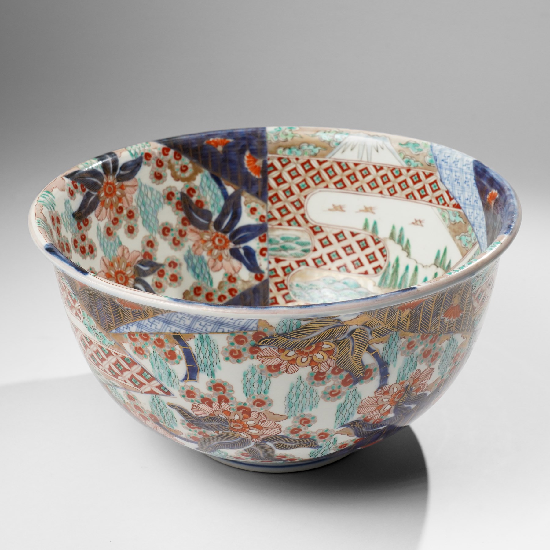 Japanese 19th century Imari bowl, painted profusely internally and externally with landscapes, flowers and traditional motifs, H16.5cm 