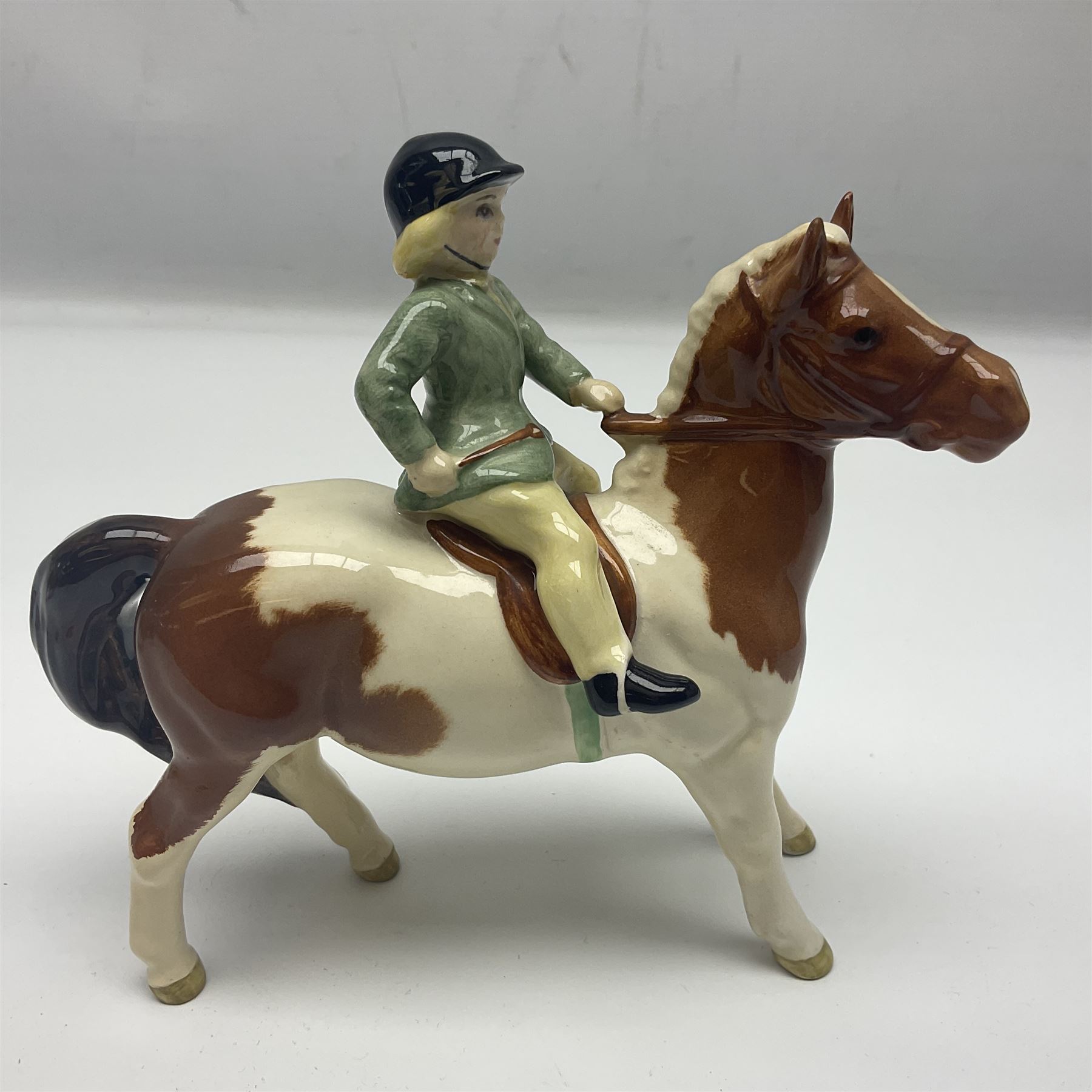 Beswick Boy on Palomino Pony no 1500 and Girl on Skewbald Pony no 1499, both with printed mark beneath 