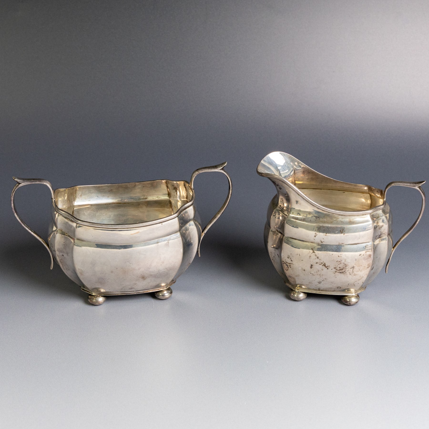 1930s silver three piece tea service, comprising teapot, milk jug and open sucrier, of oval form, the teapot with ebonised handle and finial, hallmarked S Blanckensee & Son Ltd, Chester 1931