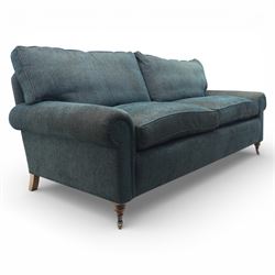 Three seat sofa upholstered in green fabric