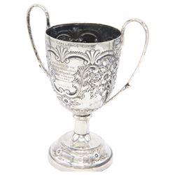 Edwardian silver twin handled trophy, engraved with presentation engraving and embossed with floral and foliate decoration to body, upon a domed circular weighted base, hallmarked 	Hammond, Creake & Co (Saint Arnaud Creake), Sheffield 1902, H22cm