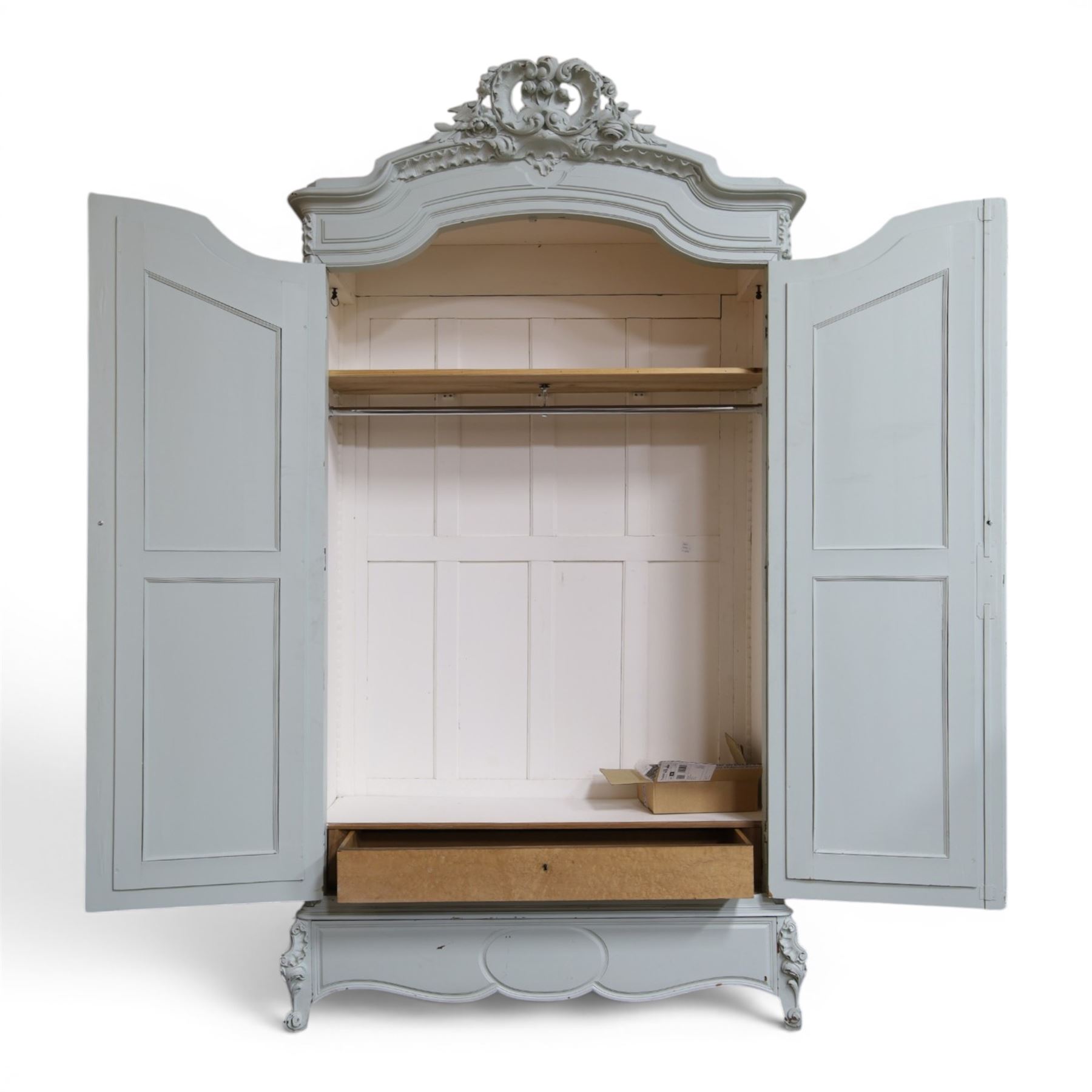 French Louis XV style pale blue painted armoire, with carved floral and foliate crest over a shaped moulded cornice, fitted with two bevelled mirror panel doors enclosing hanging space and drawer, above shaped apron, raised on carved cabriole supports