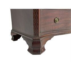 Late 19th to early 20th century Georgian design serpentine chest, moulded serpentine top with canted front corners, fitted with two short and three long cock-beaded drawers, with pressed brass handle plates and hoop handles, the canted uprights decorated with blind fretwork, on ogee bracket feet