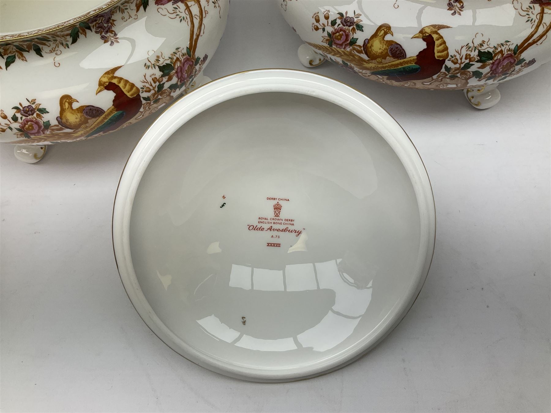 Royal Crown Derby Olde Avesbury pattern dinner and coffee service for six place settings, decorated with exotic birds amidst blossoming branches, comprising six dinner plates, six dessert plates, two tureen and covers, sauce boat and stand, oval serving platter, coffee pot, six coffee cans and six saucers, cream jug, and open sucrier, each with printed mark beneath