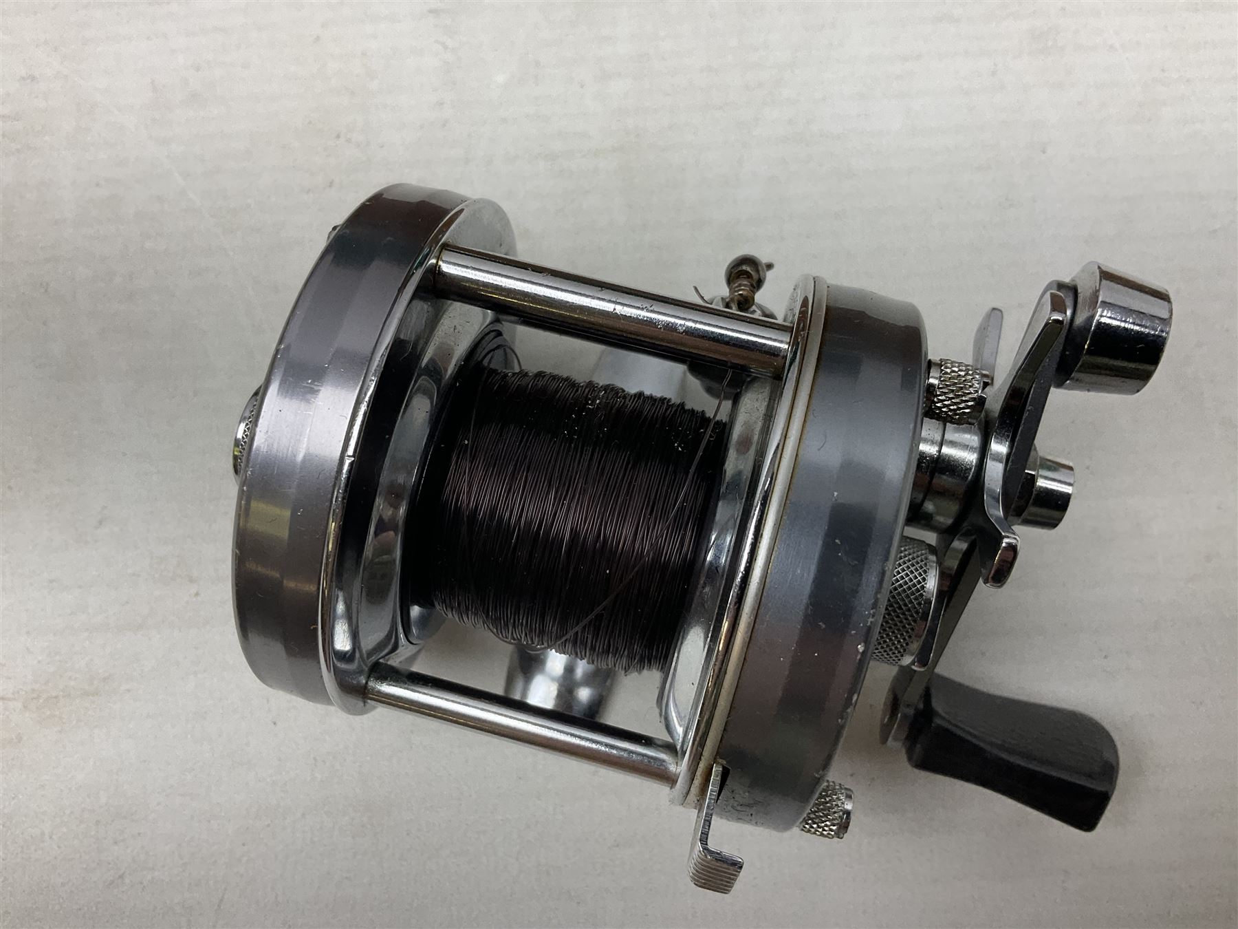 Four Abu fishing reels, comprising Ambassadeur 9000, Ambassadeur 7000, Ambassadeur 5500 and Ambassadeur 6500, together with additional line, hardy fishing bag and two wooden boxes