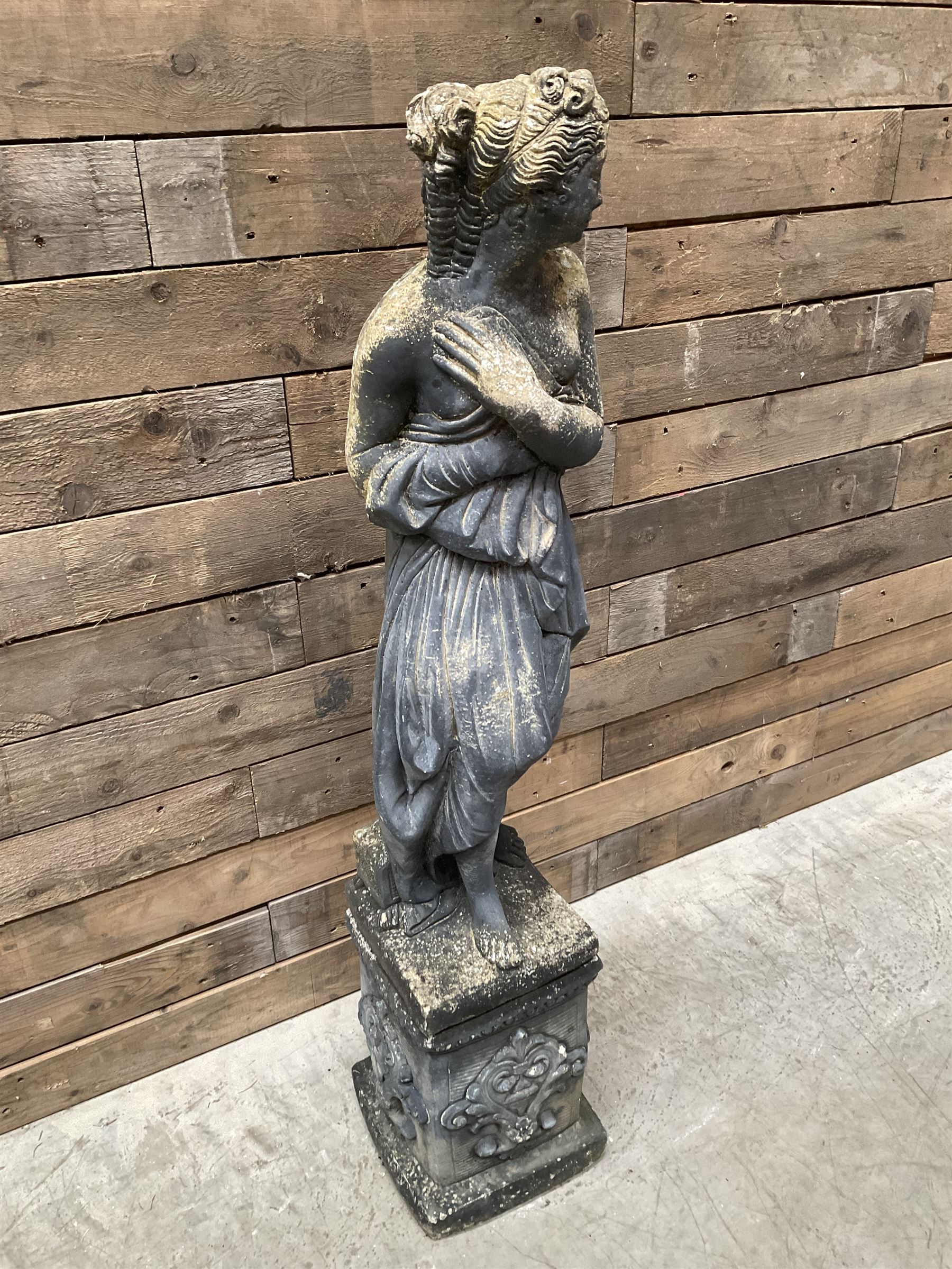 Cast stone weathered garden statue of Venus on pedestal