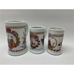 Collection of glass tankards, including three milk glass tankards painted with line boarders and flower sprigs and figures,  a metal mounted tankard with a ceramic hand painted panel, along with a selection of other metal mounted glass tankards. 