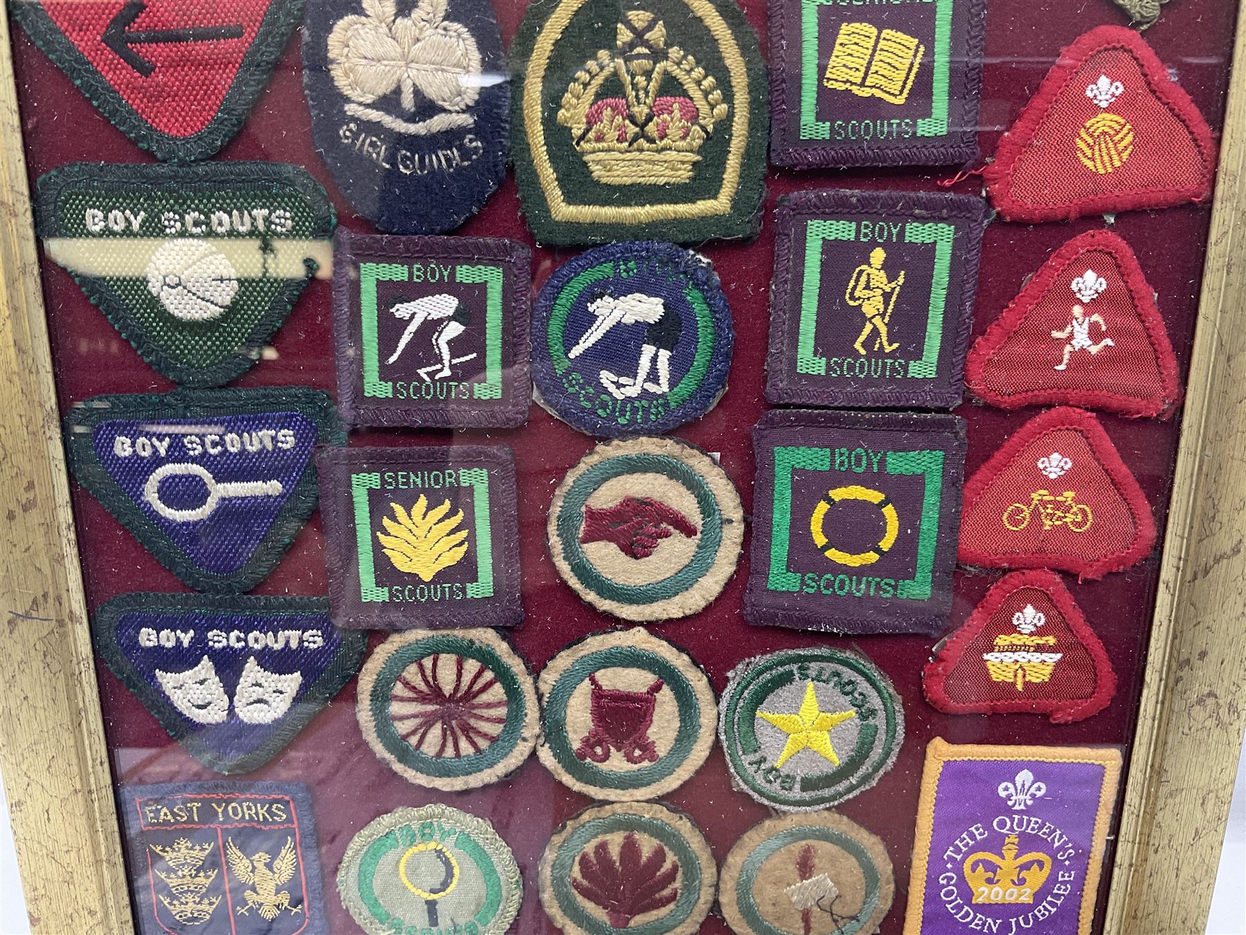 Boy Scout Interest; framed collection of Boy Scouts cloth insignias, to include badges from East Yorkshire, Northumberland, West Yorkshire, Devon, Norfolk and Derby, thirty four badges in total  