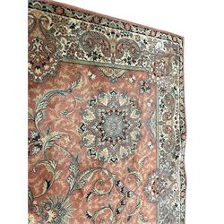 Persian design peach ground carpet, central floral medallion surrounded by scrolling foliage, decorated all over with stylised plant motifs, floral design repeating border