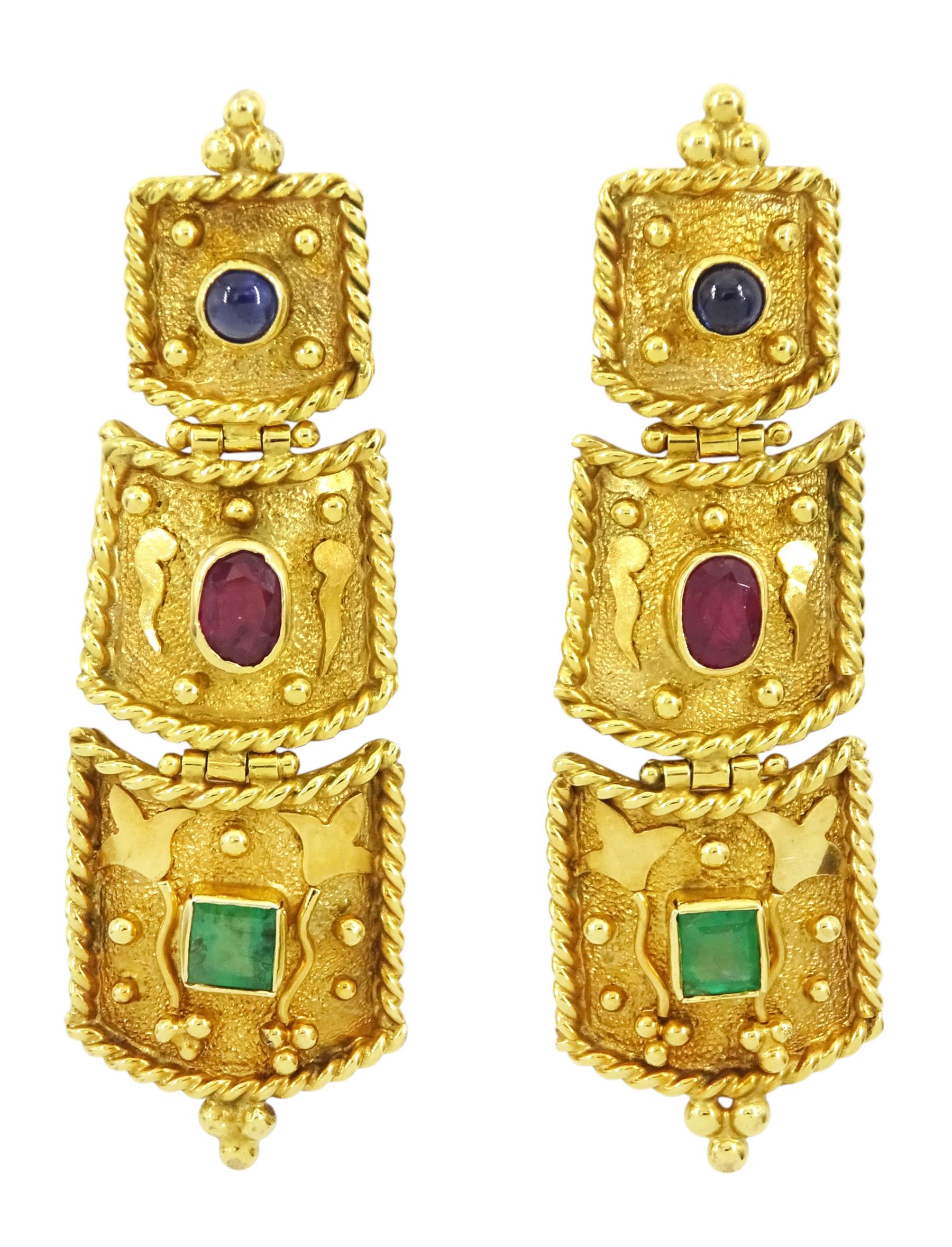 Gold emerald, ruby and sapphire pendant earrings, each three graduating panels set with a cabochon sapphire, oval cut ruby and square cut emerald
