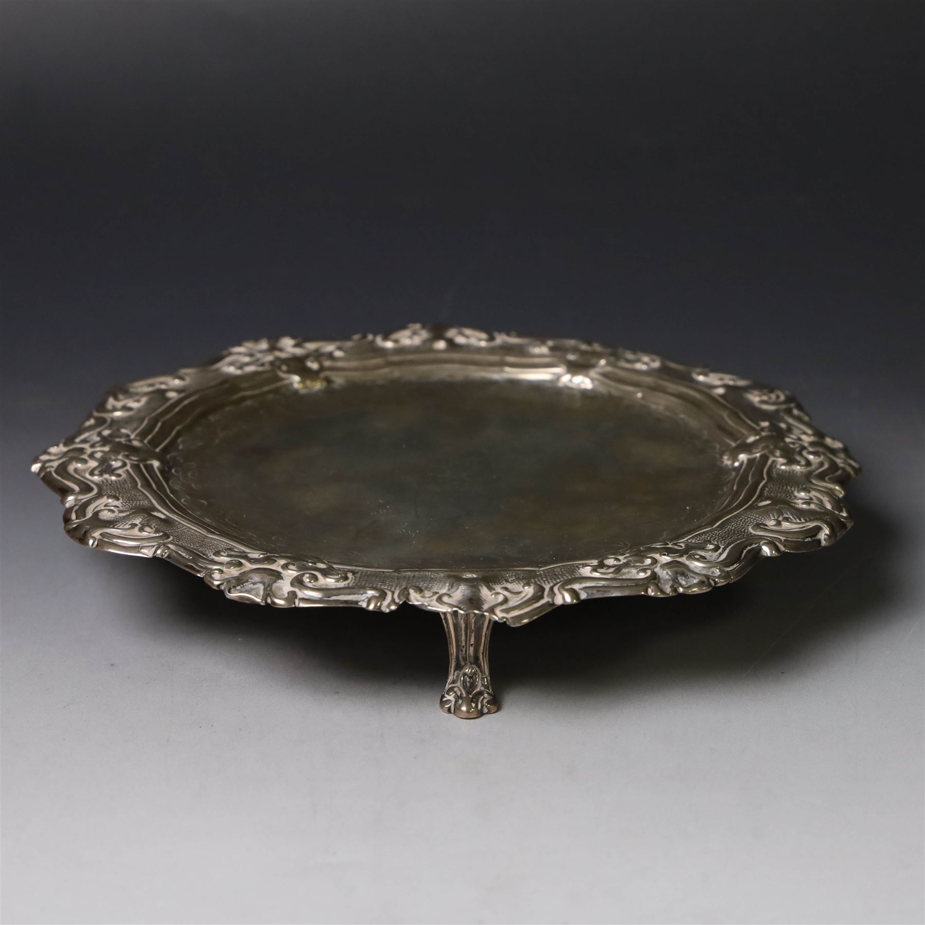 19th century continental silver waiter, of hexagonal form with stipple and scroll border, engraved with floral decoration to centre, upon three stylised paw feet, W19.2cm