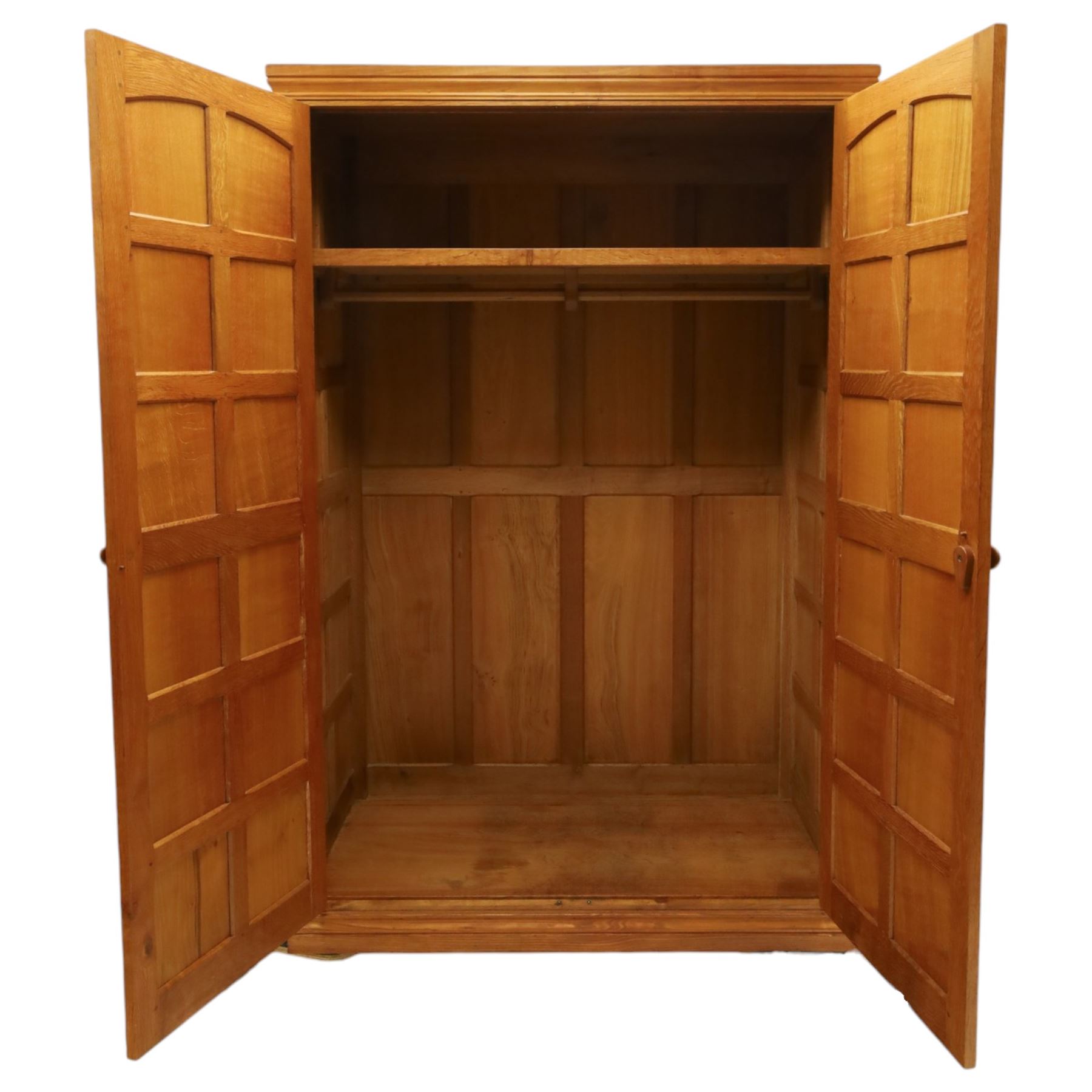 Beaverman - oak double wardrobe, enclosed by twin multi-panelled doors, Yorkshire Rose carved handles, the interior fitted with shelf and hanging rail, with signature carved beaver, by Colin Almack of Sutton, near Thirsk