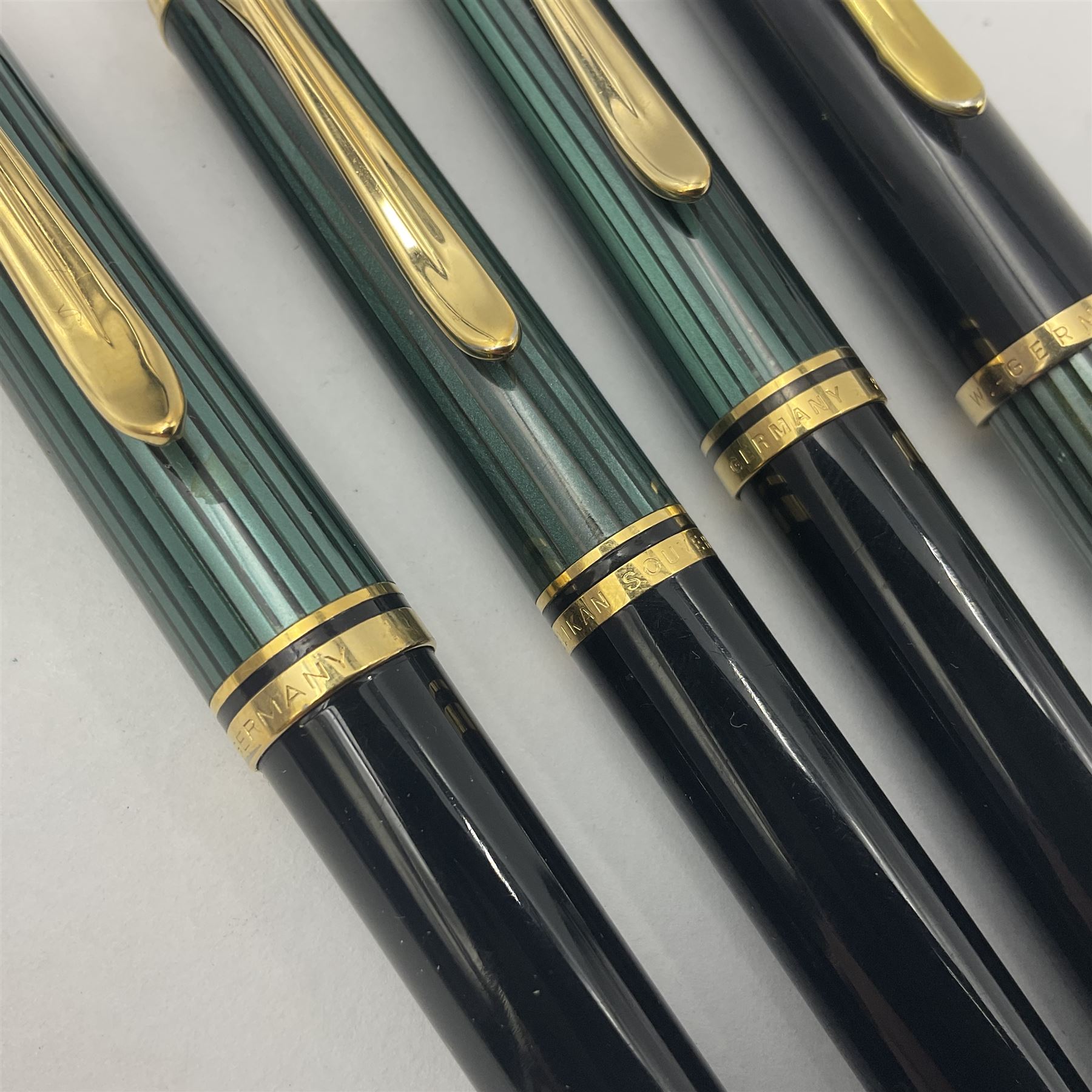 Pelikan Souveran 140 fountain pen, the green and black striped barrel with gold plated beak shaped clip and bands, with gold nib stamped 14C-585, together with matching twist ballpoint pen, push ballpoint pen and propelling pencil, largest approx L13.5cm (4)
